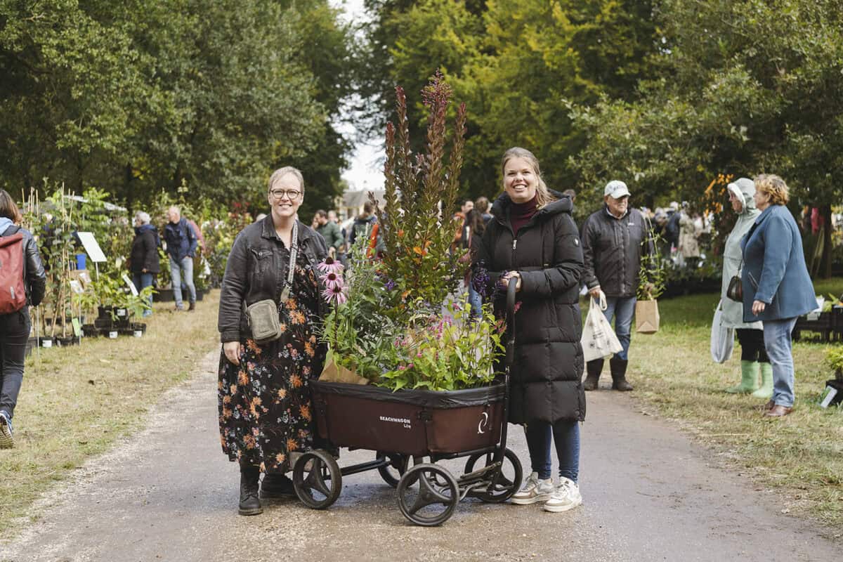 Twee mensen op de Ambachtelijke Plantenmarkt met gekochte planten in hun kar.