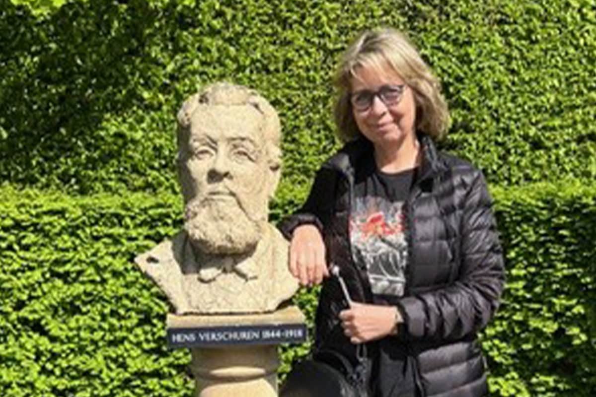 Anneke Verschuren bij het beeld van haar opa in Kasteeltuinen Arcen.